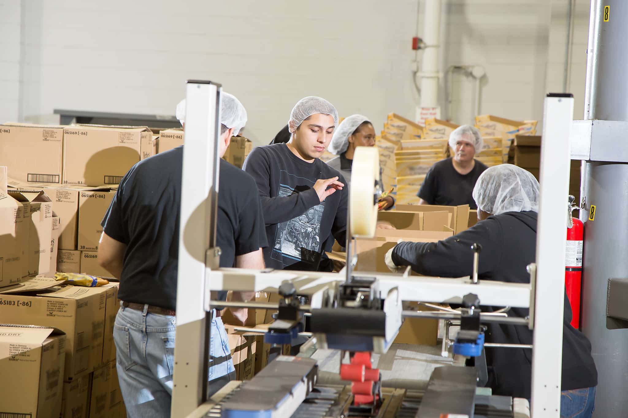 Team members assemble and prepare retail-ready cartons, the detail-level work behind a 3PL for CPG brands managing make-to-order volume.