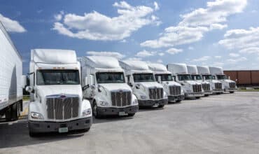 Colonial Cartage Corporation fleet of trucks lined up at the terminal